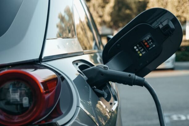 Close-up of an electric vehicle being charged, highlighting modern clean energy technology.